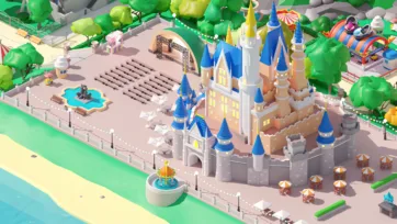3D low poly medieval castle complex with blue towers, outdoor amphitheater seating, decorative fountain and carnival food stands