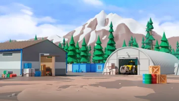 Industrial timber processing facility with storage buildings, equipment garage, and material handling areas set against mountain forest backdrop
