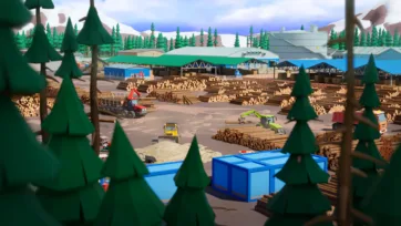 Expansive lumber yard overview showing multiple timber processing operations, equipment, and storage areas surrounded by forest